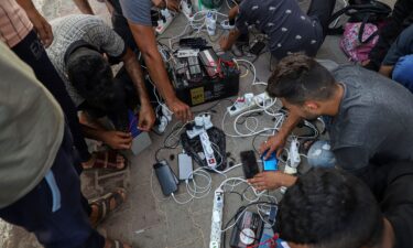 Palestinians struggle to charge and use their mobile phones amid electricity cuts and telecommunication blackouts across Gaza.