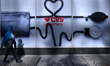 CVS will change the way it prices drugs. A woman walks past a CVS Pharmacy in Washington