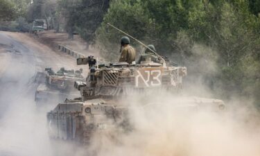 Israeli military tanks roll near the border with the Gaza Strip on December 5