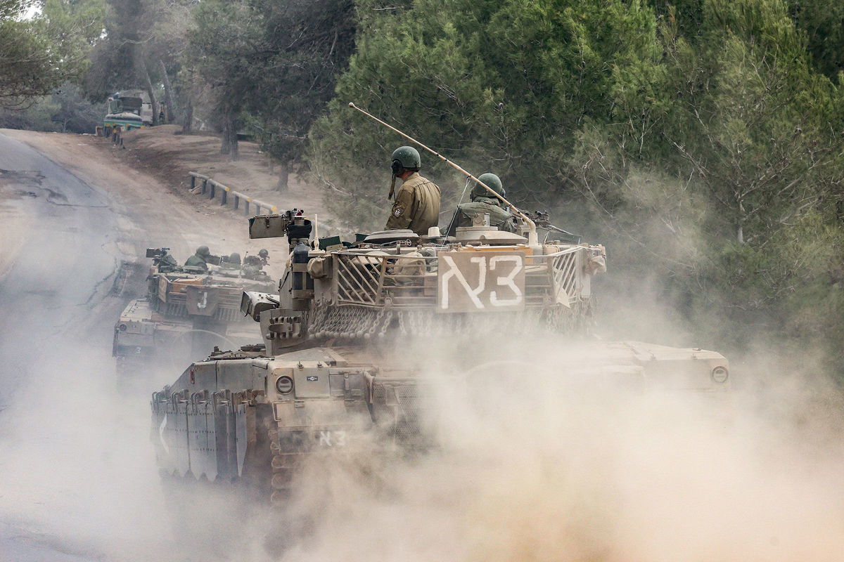 <i>Menahem Kahana/AFP/Getty Images</i><br/>Israeli military tanks roll near the border with the Gaza Strip on December 5