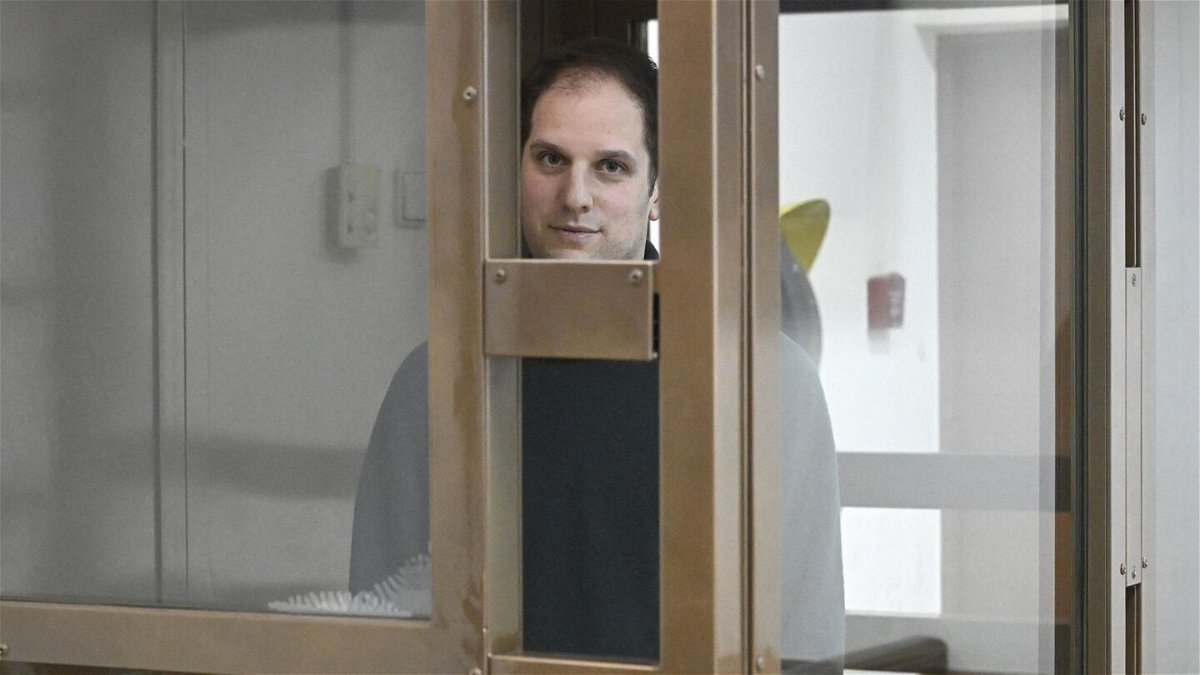 <i>Dmitry Serebryakov/AP</i><br/>Wall Street Journal reporter Evan Gershkovich stands in a glass cage in a Moscow courtroom on December 14.