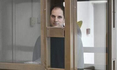 Wall Street Journal reporter Evan Gershkovich stands in a glass cage in a Moscow courtroom on December 14.