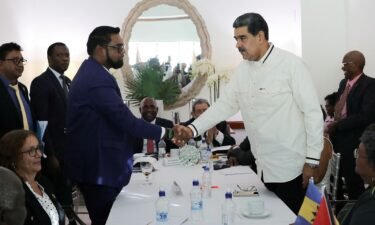Guyanese President Irfaan Ali and Venezuela's President Nicolas Maduro shake hands as they meet amid tensions over a border dispute