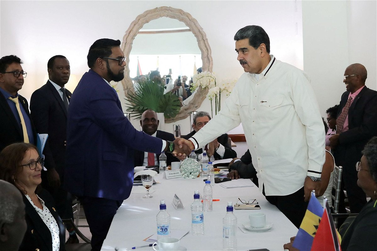 <i>Miraflores Palace/Reuters</i><br/>Guyanese President Irfaan Ali and Venezuela's President Nicolas Maduro shake hands as they meet amid tensions over a border dispute