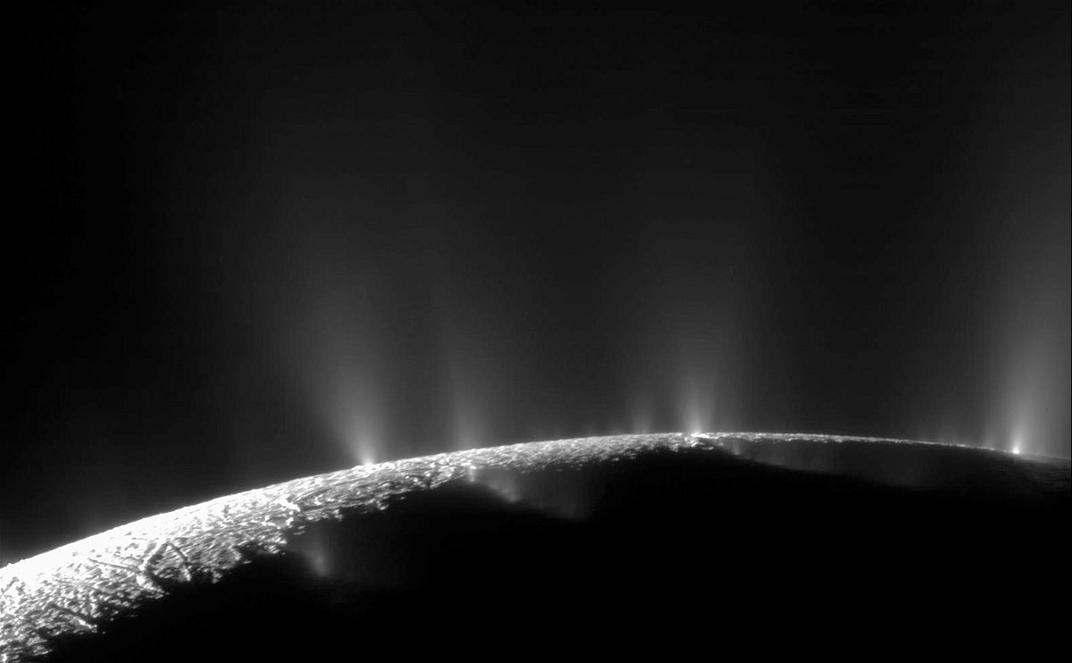 <i>NASA/JPL/Space Science Institute</i><br/>Plumes can be seen releasing water vapor and organic compounds into space at the south pole of Saturn's moon Enceladus.