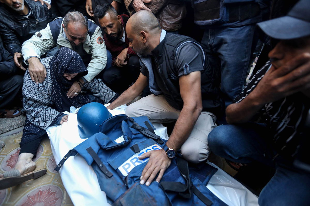 <i>Ahmad Hasaballah/Getty Images</i><br/>Mourners gather around the body of Al Jazeera cameraman Abu Daqqa on Saturday.