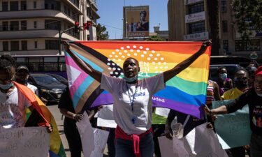 A woman holds a pride flag during a protest organized by The Queer Republic in Nairobi in January 2022.