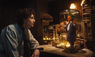 Timothée Chalamet appears as Willy Wonka and Hugh Grant as an Oompa Loompa in "Wonka."