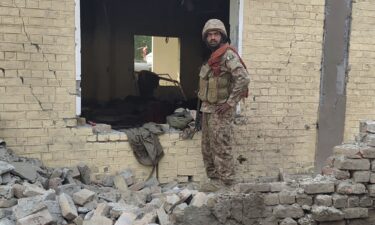 A Pakistani soldier examines damage at the site of a bombing at a police station near Dera Ismail Khan on Tuesday