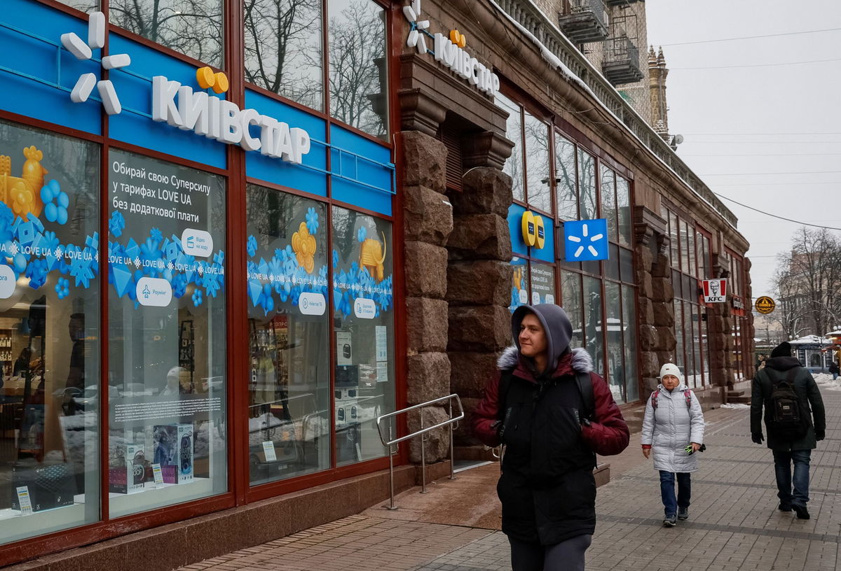 <i>Alina Smutko/Reuters</i><br/>People walk past a store of Ukraine's telecommunications company Kyivstar