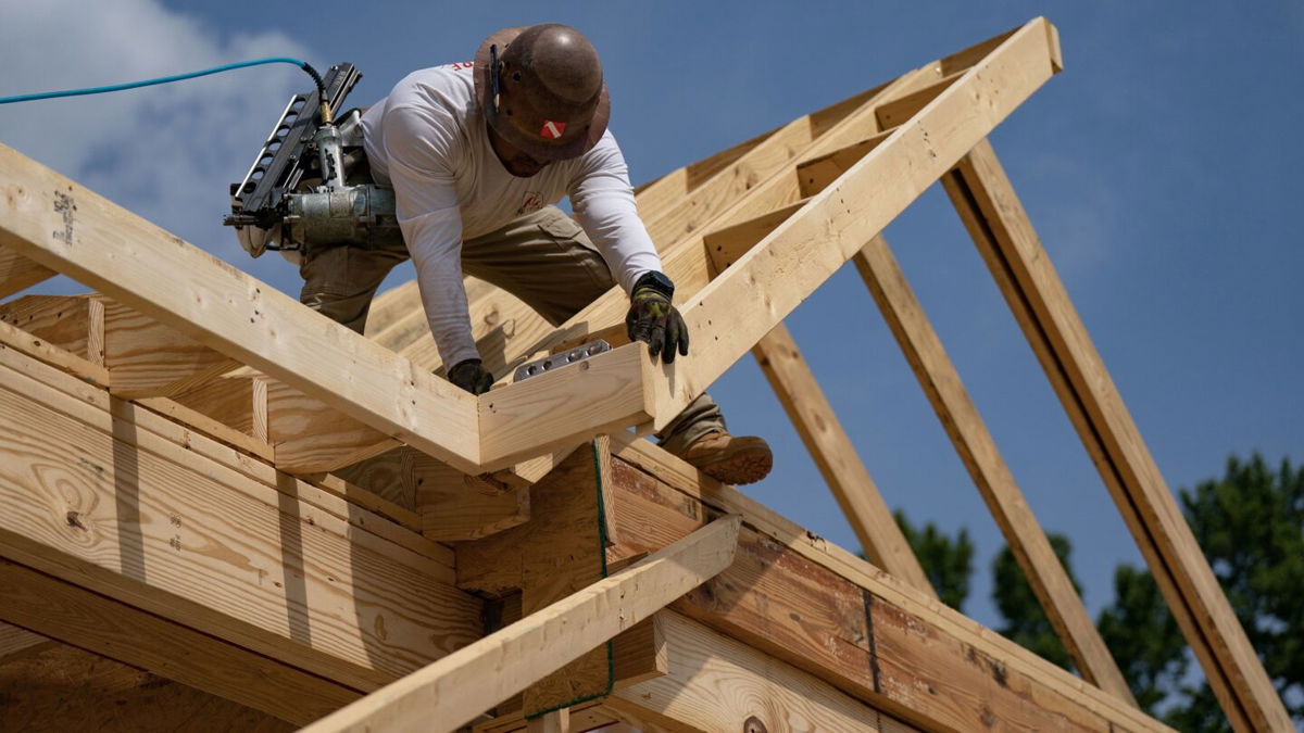 <i>Allison Joyce/Bloomberg via Getty Images</i><br/>A worker builds a home in Lillington
