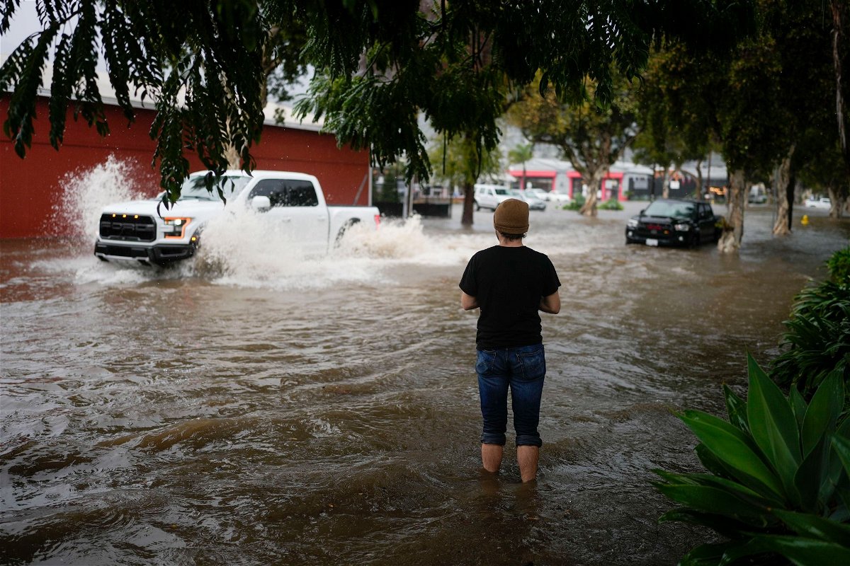 <i>Jae C. Hong/AP</i><br/>A man watches motorists drive through a flooded street during a rain storm Thursday in Santa Barbara