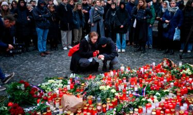 Czech Republic's Prime Minister Petr Fiala walks to lay flowers outside the headquarters of Charles University for victims of mass shooting in Prague on December 22.