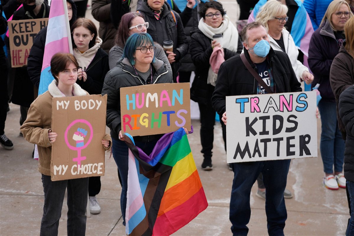<i>Rick Bowmer/AP/FILE</i><br/>People gather in support of transgender youth during a rally at the Utah State Capitol Tuesday
