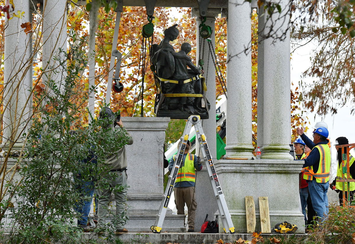 <i>Bob Self/The Florida Times-Union/AP</i><br/>Crews begin the process of removing Confederate statues from a monument in Jacksonville's Springfield Park early Wednesday.