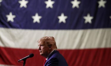 Republican Presidential candidate former President Donald Trump looks on during a campaign rally on December 17