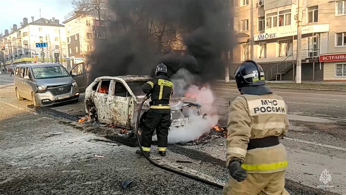 <i>Russia Emergency Situations Ministry telegram channel via AP</i><br/>Firefighters extinguish burning cars after shelling in Belgorod on Saturday.