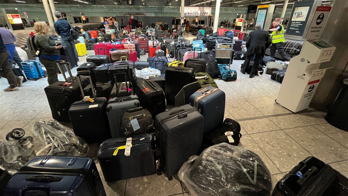 <i>Jonas Walzberg/picture-alliance/dpa/AP</i><br/>Suitcases can really pile up in a baggage claim area