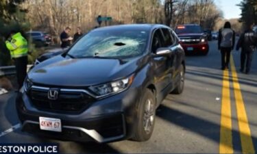 A Massachusetts driver was injured when a piece of metal crashed through her windshield and hit her in the head