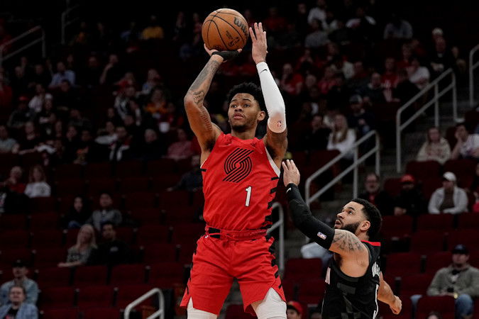 Portland Trail Blazers guard Anfernee Simons (1) scores as Houston Rockets guard Fred VanVleet looks on during the first quarter of Wednesday night's game in Houston.