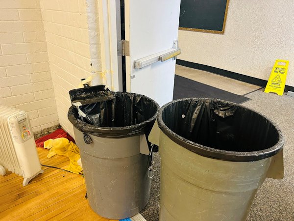 Large lined trash cans catch leaks from the ceiling at Crook County Middle School during January storm