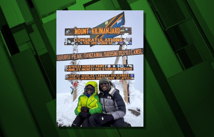 Bend father-son, Philip and Jayden Sangue, cheer from atop Mount Kilimanjaro
