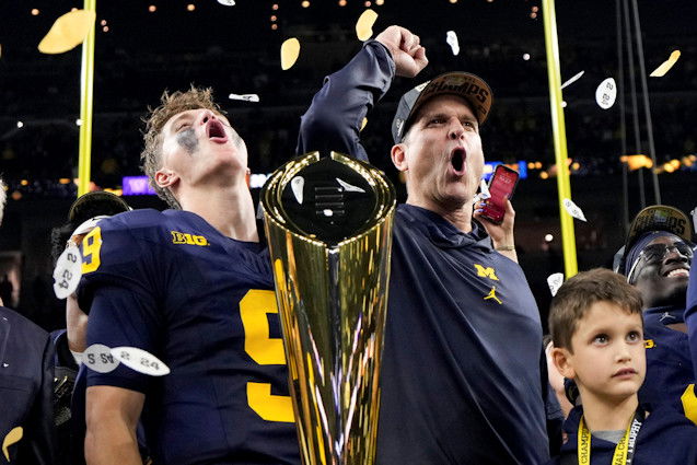 Michigan head coach Jim Harbaugh and quarterback J.J. McCarthy celebrate with the trophy after their win against Washington in the national championship NCAA College Football Playoff game Monday in Houston