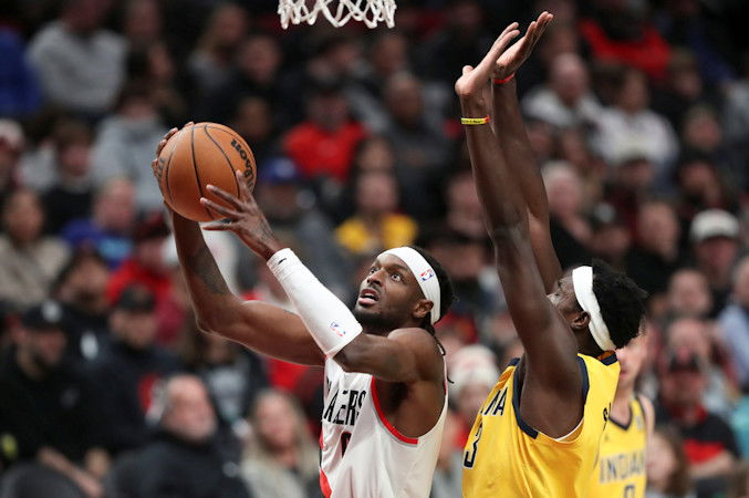 Portland Trail Blazers forward Jerami Grant, left, drives to the basket as Indiana Pacers forward Pascal Siakam defends during the first half of  Friday night's NBA contest in Portland