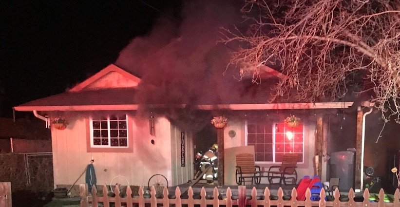 Firefighters worked to put out NE Prineville house fire early Tuesday morning
