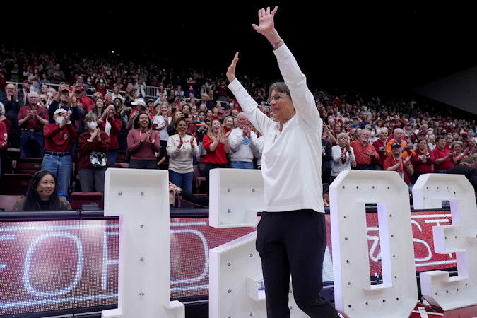 Stanford head coach Tara VanDerveer waves to the crowd after breaking the college basketball record for wins with her team's victory over Oregon State in an NCAA college basketball game on Sunday at Stanford, Calif.