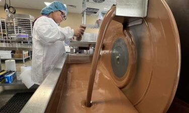An employee of Vermont Nut Free Chocolates molds chocolates in the company’s Colchester production facility.