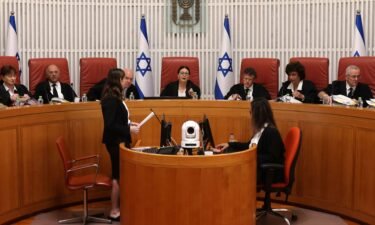 President of the Israeli Supreme Court Esther Hayut (C) and judges assemble to hear petitions against the law that blocks the court from potentially ordering the prime minister to recuse himself from office
