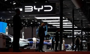Security guards stand at the BYD booth at the Auto Shanghai show