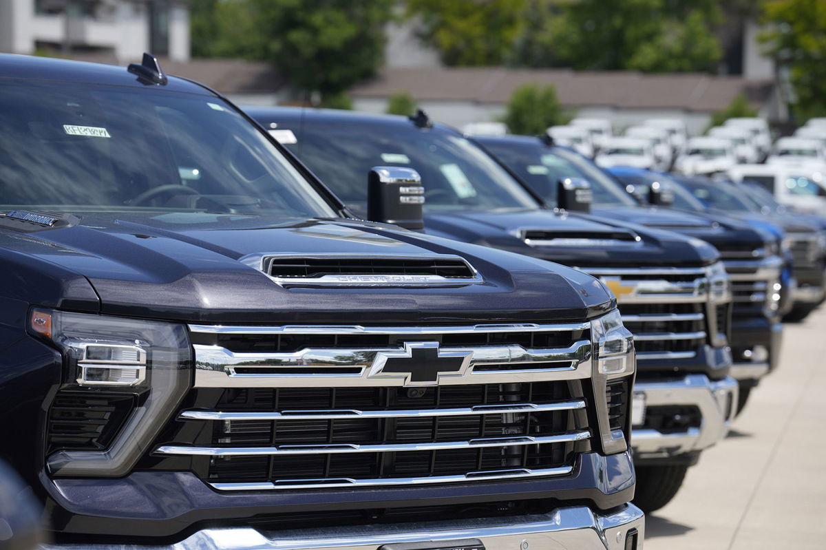 <i>David Zalubowski/AP</i><br/>Silverado pickup trucks sit in a long row at a Chevrolet dealership in June. Fourth quarter sales of some GM vehicles