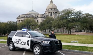 A Capitol Police officer warns off passersby as they respond to a bomb threat at the Mississippi State Capitol in Jackson on Wednesday morning.