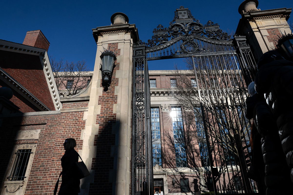 <i>Craig F. Walker/The Boston Globe/Getty Images</i><br/>A pedestrian passes a gate to Harvard Yard on Massachusetts Ave. in Cambridge