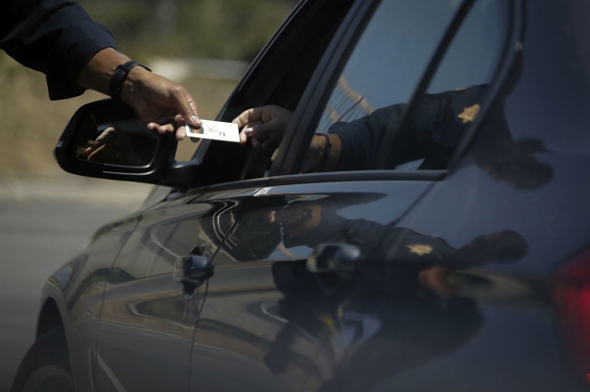 <i>Chris Carlson/AP/File</i><br/>The report’s findings show that drivers perceived to be from a racial or ethnic group of color were searched by law enforcement at higher rates than those perceived as White.