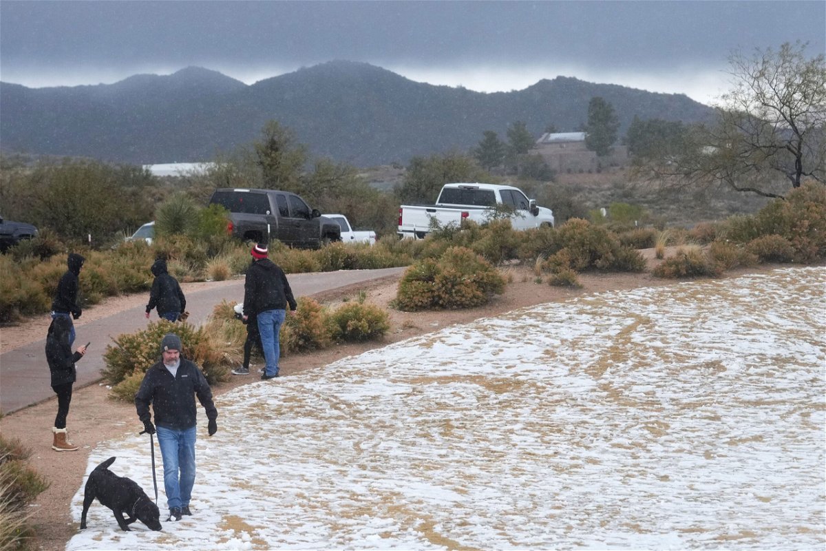 <i>Joe Rondone/The Republic/USA Today Network</i><br/>Snow and hail accumulate on the ground in Scottsdale
