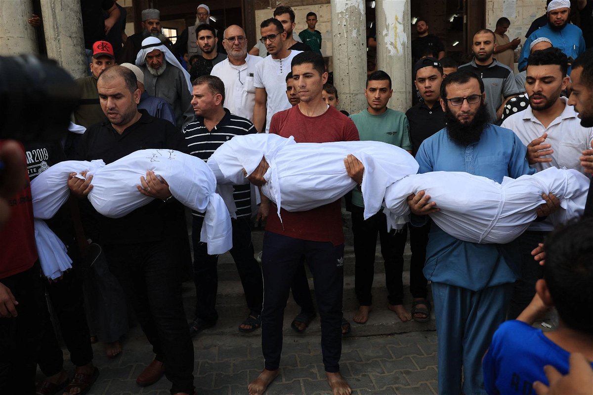 <i>Said Khatib/AFP/Getty Images</i><br/>Relatives carry the bodies of children from the Abu Quta family who were killed in Israeli strikes on the Palestinian city of Rafah in the southern Gaza Strip