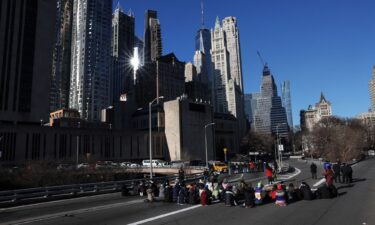 Pro-Palestinian demonstrators block a Brooklyn Bridge roadway during a 'Shut it Down for Palestine' protest in New York City.