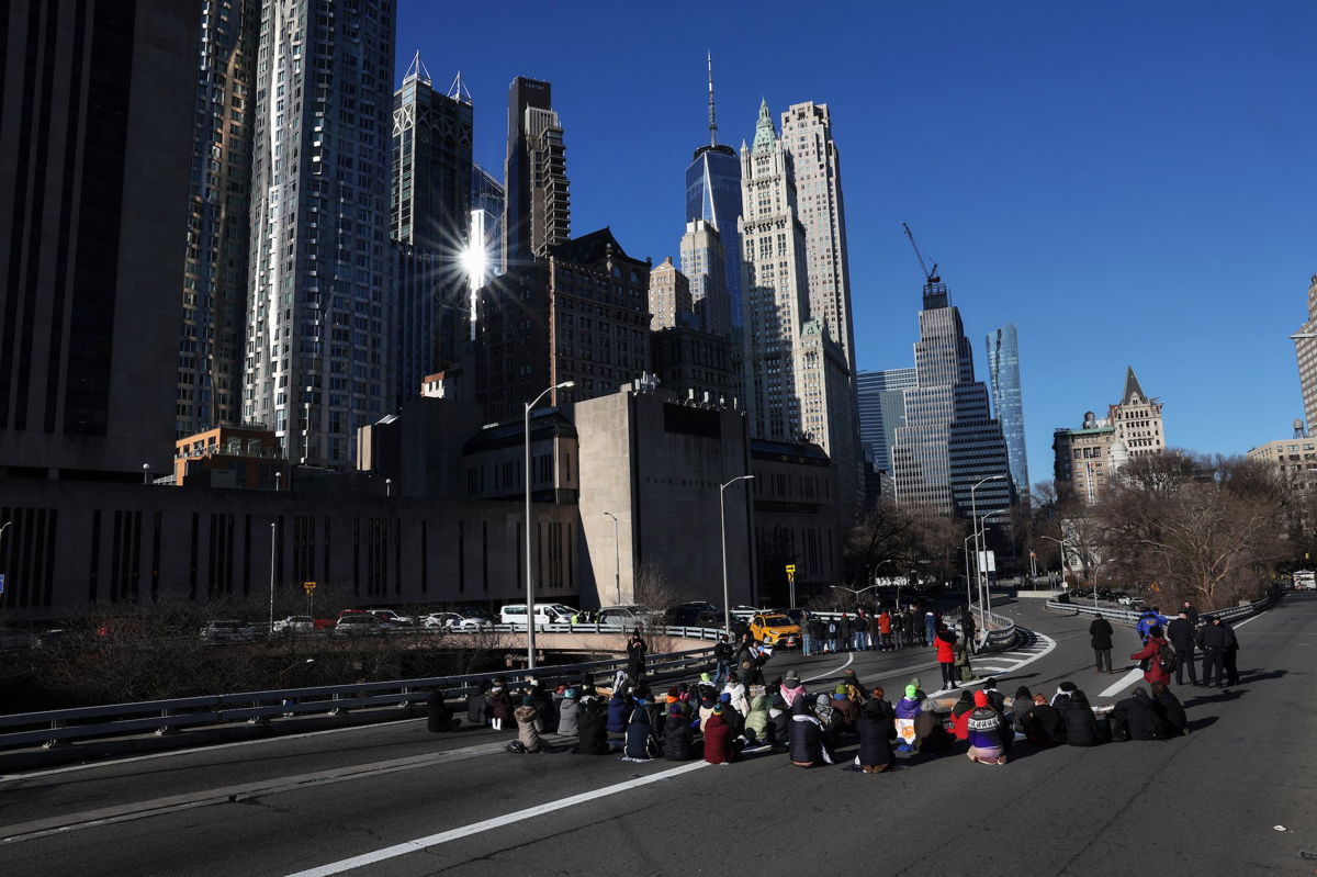 <i>Shannon Stapleton/Reuters</i><br/>Pro-Palestinian demonstrators block a Brooklyn Bridge roadway during a 'Shut it Down for Palestine' protest in New York City.
