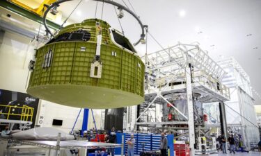 The Orion pressure vessel for NASA’s Artemis III mission is shown being lifted by crane for its move onto a work stand at NASA’s Kennedy Space Center in Florida in 2021.