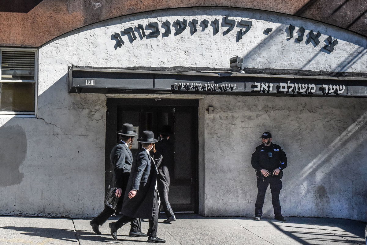 <i>Stephanie Keith/Getty Images</i><br/>A member of the New York Police Department patrols in front of a synagogue on October 13