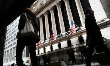 People walk by the New York Stock Exchange in the Financial District on March 7