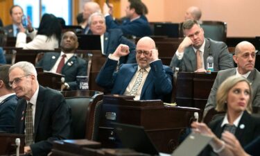 Ohio state Rep. Gary Click pumps his fists after the House overrode Gov. DeWine's veto of House Bill 68