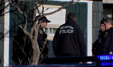 Police are seen last year outside Lee Carter's home in Houston. A malnourished woman who weighed about 70 pounds was found in Carter's garage