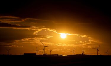 Wind turbines are seen at sunset in Williamsburg