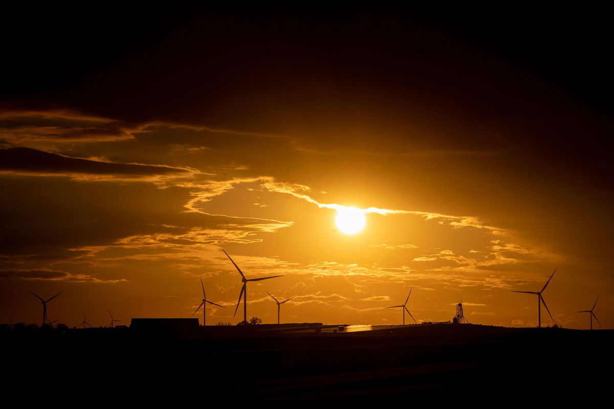 <i>Stefani Reynolds/AFP/Getty Images</i><br/>Wind turbines are seen at sunset in Williamsburg