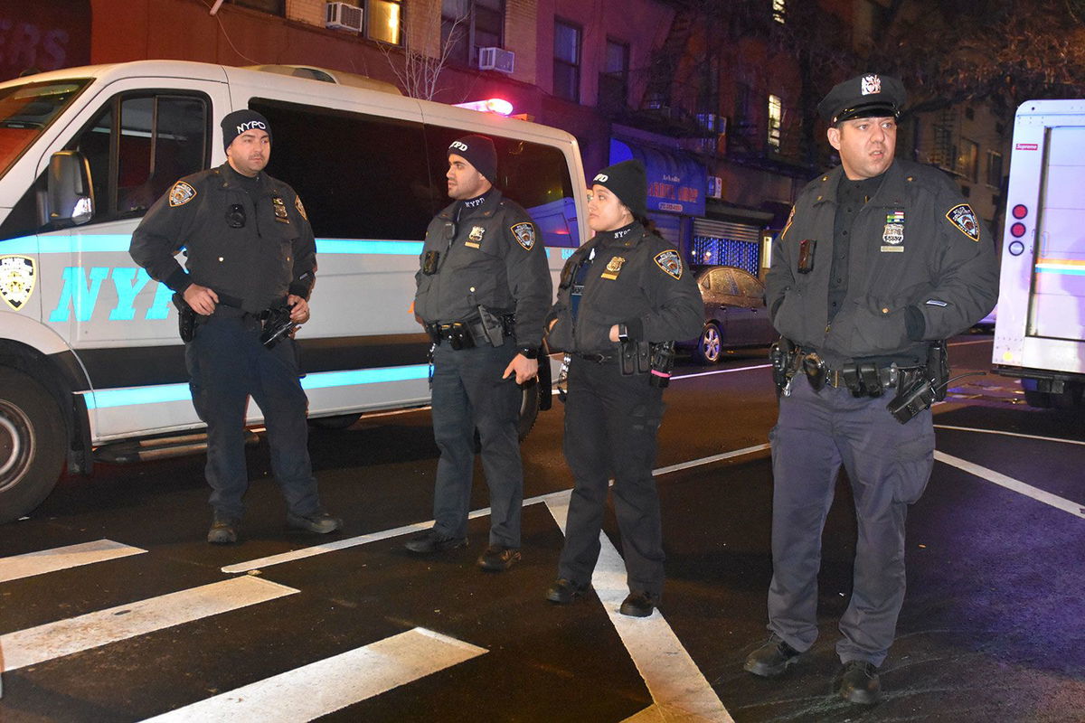 <i>Kyle Mazza/Anadolu Agency/Getty Images</i><br/>Police officers stand guard on a road after an assailant attacked three NYPD officers with a machete during the new year celebrations in New York on December 31