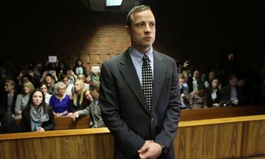 Oscar Pistorius poses next to his girlfriend Reeva Steenkamp in Johannesburg on January 26